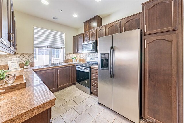 15405 Ashley Ct, Whittier, CA 90603 - kitchen with stainless steel appliances, a sink, backsplash, light countertops, and recessed lighting