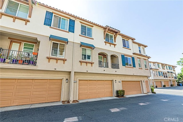 15405 Ashley Ct, Whittier, CA 90603 - view of front facade featuring stucco siding, an attached garage, and a tile roof