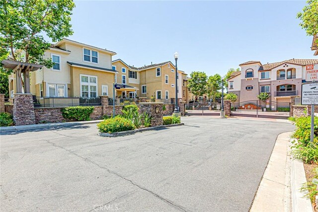 15405 Ashley Ct, Whittier, CA 90603 - view of asphalt road featuring a residential view, street lighting, a gate, curbs, and a gated entry