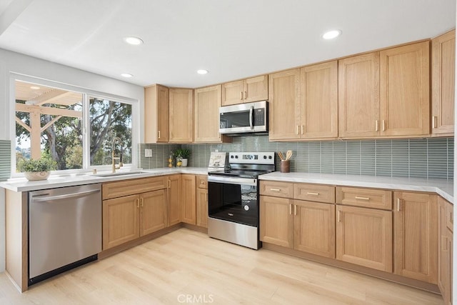 28116 Calle Casal, Mission Viejo, CA 92692 - kitchen with stainless steel appliances, light countertops, decorative backsplash, a sink, and recessed lighting