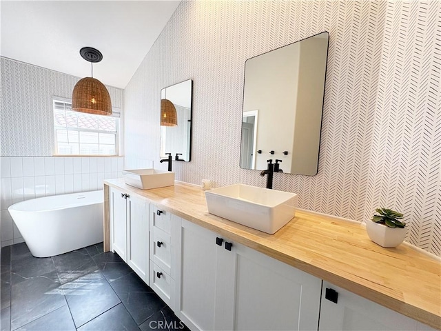 4 Imperial Aisle, Irvine, CA 92606 - bathroom with wallpapered walls, double vanity, a soaking tub, lofted ceiling, and tile patterned flooring
