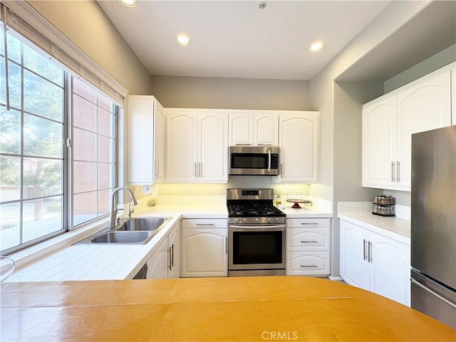 4 Imperial Aisle, Irvine, CA 92606 - kitchen with appliances with stainless steel finishes, light countertops, white cabinetry, and recessed lighting