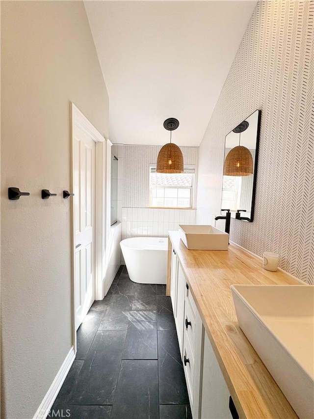 4 Imperial Aisle, Irvine, CA 92606 - bathroom with wallpapered walls, a freestanding bath, and double vanity