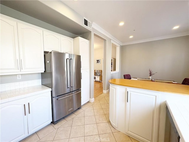 4 Imperial Aisle, Irvine, CA 92606 - kitchen with high end refrigerator, tile counters, white cabinetry, recessed lighting, and light tile patterned floors