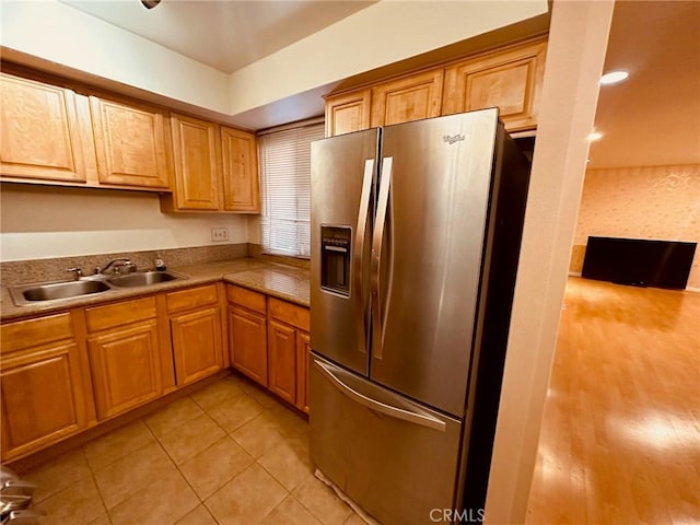 605 N Louise St Unit 106, Glendale, CA 91206 - kitchen with stainless steel refrigerator with ice dispenser, light tile patterned floors, and brown cabinets