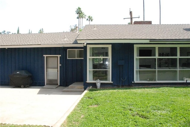 360 Campbell Ave, Redlands, CA 92373 - back of property with a shingled roof, a yard, and board and batten siding