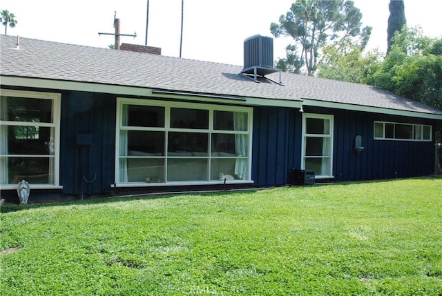 360 Campbell Ave, Redlands, CA 92373 - rear view of house with board and batten siding, a yard, a shingled roof, central AC unit, and a chimney