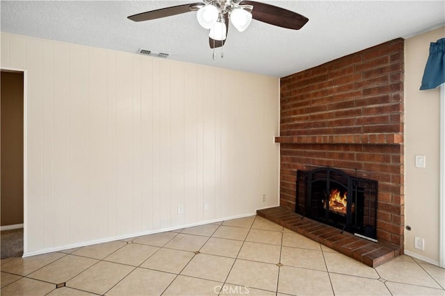 663 Redwood Ave, Upland, CA 91786 - unfurnished living room featuring a brick fireplace, ceiling fan, a textured ceiling, baseboards, and light tile patterned floors