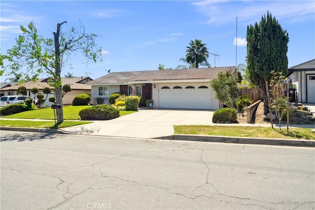 663 Redwood Ave, Upland, CA 91786 - view of front facade featuring an attached garage, driveway, and a front yard
