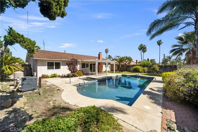 663 Redwood Ave, Upland, CA 91786 - view of pool featuring a fenced backyard, a patio area, and cooling unit