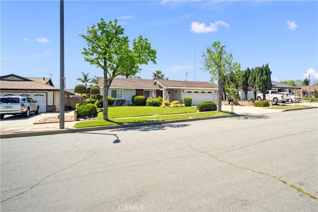 663 Redwood Ave, Upland, CA 91786 - ranch-style house featuring a garage, concrete driveway, and a front lawn