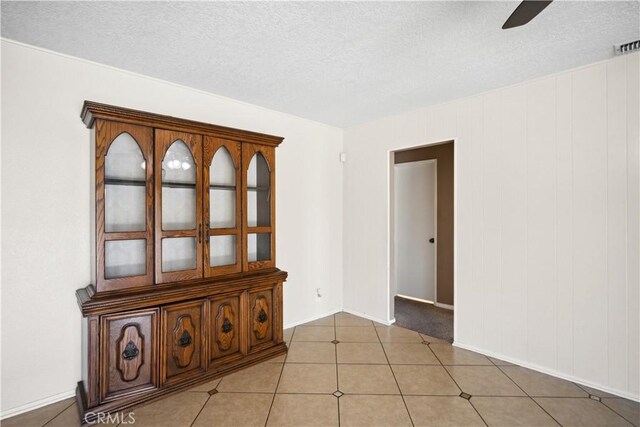 663 Redwood Ave, Upland, CA 91786 - unfurnished room with a ceiling fan, a textured ceiling, baseboards, and light tile patterned floors