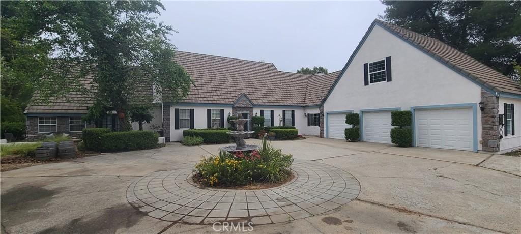 43275 Calle Capistrano, Temecula, CA 92590 - view of front of house featuring curved driveway, stucco siding, and stone siding