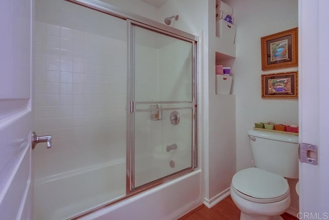 14676 Via Fiesta Unit 2, San Diego, CA 92127 - bathroom featuring toilet, enclosed tub / shower combo, baseboards, and wood finished floors