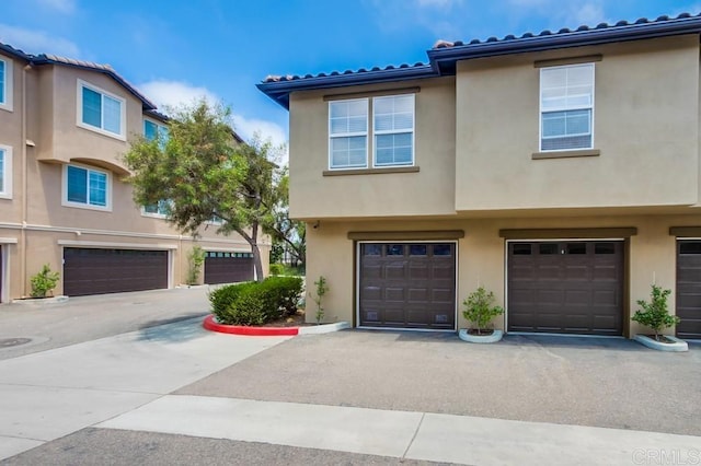 14676 Via Fiesta Unit 2, San Diego, CA 92127 - view of property featuring a garage, stucco siding, and a tile roof