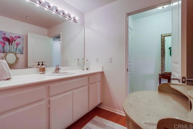 14676 Via Fiesta Unit 2, San Diego, CA 92127 - bathroom featuring wood finished floors, vanity, and baseboards