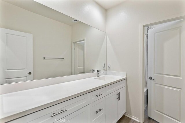 18106 Meridian Ln, Saugus, CA 91350 - bathroom with vanity, wood finished floors, and a tub