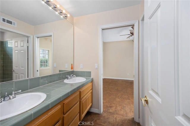5675 W Overlook Dr, Rancho Cucamonga, CA 91739 - bathroom with double vanity, baseboards, and a ceiling fan