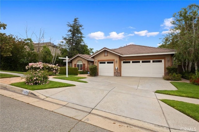5675 W Overlook Dr, Rancho Cucamonga, CA 91739 - ranch-style home featuring an attached garage, concrete driveway, a tiled roof, and stucco siding
