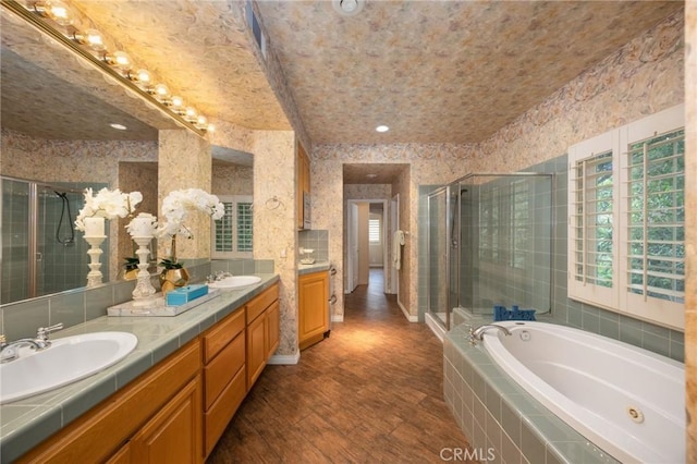 5675 W Overlook Dr, Rancho Cucamonga, CA 91739 - bathroom featuring double vanity, a stall shower, a tub with jets, and wood finished floors