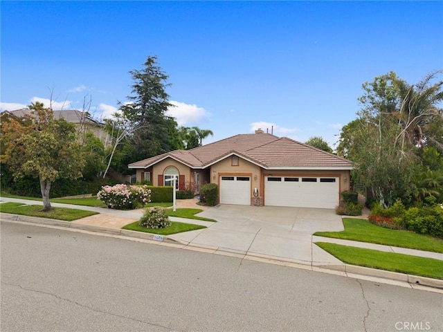 5675 W Overlook Dr, Rancho Cucamonga, CA 91739 - single story home with an attached garage, concrete driveway, stucco siding, a tiled roof, and a front lawn