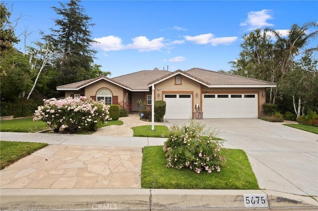5675 W Overlook Dr, Rancho Cucamonga, CA 91739 - ranch-style home with a tiled roof, concrete driveway, a garage, and a front lawn