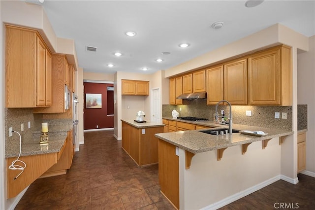 5675 W Overlook Dr, Rancho Cucamonga, CA 91739 - kitchen with a sink, a peninsula, gas cooktop, under cabinet range hood, and light stone counters