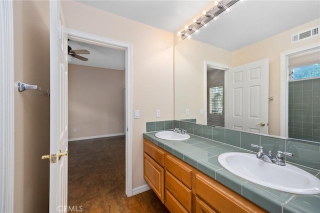 5675 W Overlook Dr, Rancho Cucamonga, CA 91739 - full bathroom with double vanity, ceiling fan, and baseboards