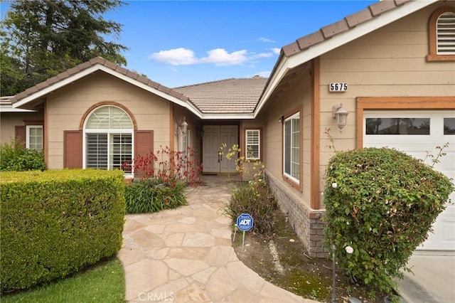 5675 W Overlook Dr, Rancho Cucamonga, CA 91739 - view of exterior entry with an attached garage
