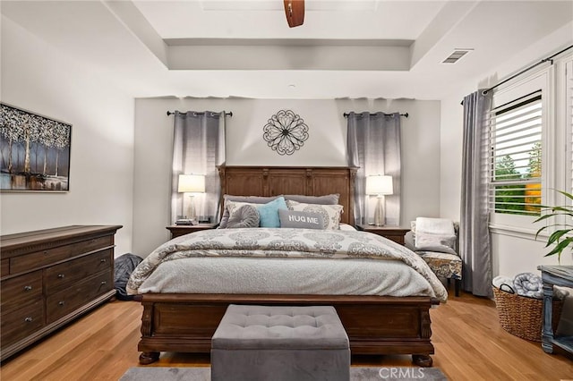 133 Valley Ridge Dr, Paradise, CA 95969 - bedroom with light wood-style flooring, a raised ceiling, and a ceiling fan