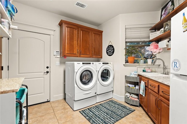 133 Valley Ridge Dr, Paradise, CA 95969 - washroom featuring cabinet space, washing machine and dryer, and light tile patterned floors