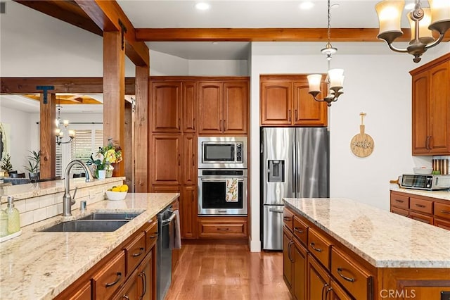 133 Valley Ridge Dr, Paradise, CA 95969 - kitchen with appliances with stainless steel finishes, a chandelier, brown cabinetry, light stone countertops, and beamed ceiling
