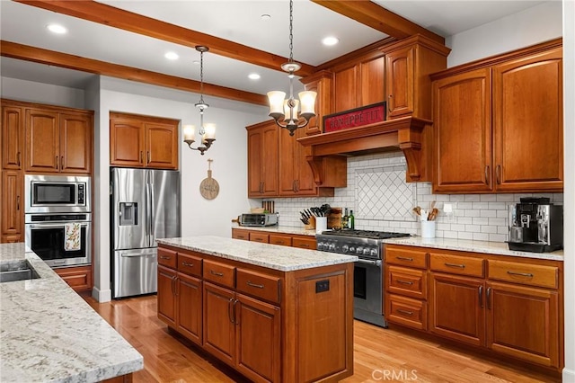 133 Valley Ridge Dr, Paradise, CA 95969 - kitchen with appliances with stainless steel finishes, a kitchen island, backsplash, light wood-type flooring, and beam ceiling