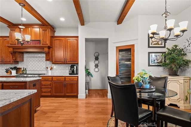 133 Valley Ridge Dr, Paradise, CA 95969 - kitchen with beam ceiling, a chandelier, tasteful backsplash, hanging light fixtures, and light wood-type flooring