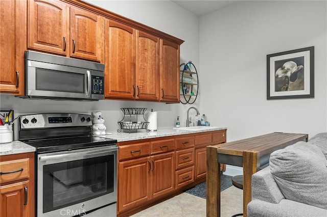 133 Valley Ridge Dr, Paradise, CA 95969 - kitchen with stainless steel appliances, brown cabinets, and light stone counters
