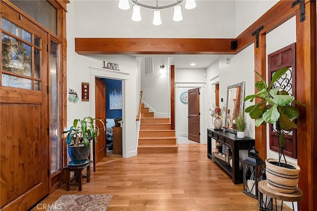 133 Valley Ridge Dr, Paradise, CA 95969 - entryway with a barn door, stairs, light wood-style flooring, a chandelier, and recessed lighting