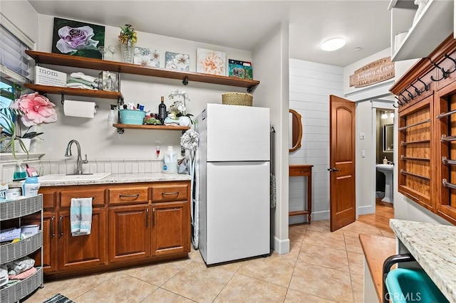 133 Valley Ridge Dr, Paradise, CA 95969 - kitchen with freestanding refrigerator, open shelves, light tile patterned flooring, and light stone countertops