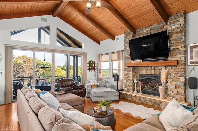 133 Valley Ridge Dr, Paradise, CA 95969 - living area featuring wood finished floors, a stone fireplace, ceiling fan, a wood ceiling with exposed beams, and high vaulted ceiling