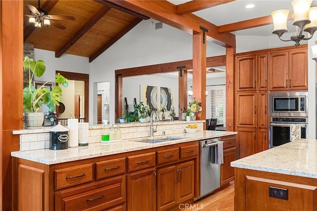 133 Valley Ridge Dr, Paradise, CA 95969 - kitchen with stainless steel appliances, light stone counters, brown cabinets, light wood-style floors, and a chandelier