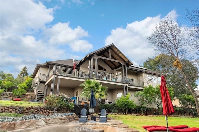 133 Valley Ridge Dr, Paradise, CA 95969 - back of house featuring stucco siding, stairs, a lawn, and a balcony
