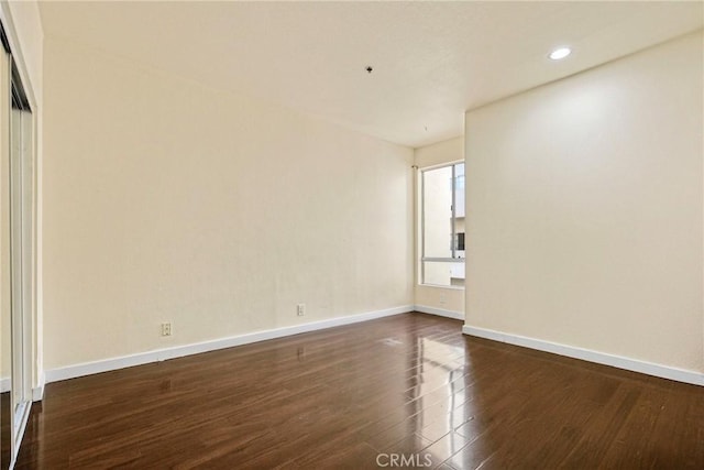 19350 Sherman Way Unit 223, Reseda, CA 91335 - unfurnished room featuring dark wood-type flooring, baseboards, and recessed lighting
