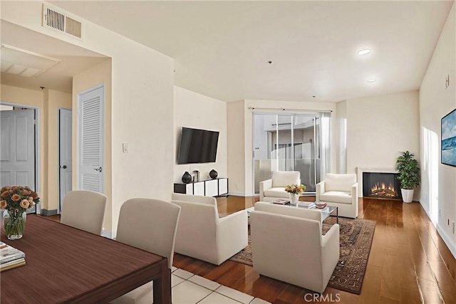 19350 Sherman Way Unit 223, Reseda, CA 91335 - living area with wood finished floors, a warm lit fireplace, recessed lighting, and baseboards
