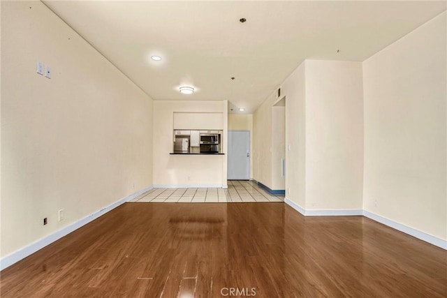 19350 Sherman Way Unit 223, Reseda, CA 91335 - unfurnished living room with wood finished floors and baseboards