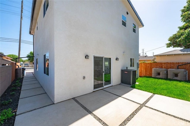 941 E 97th St, Los Angeles, CA 90002 - back of property featuring stucco siding, cooling unit, and a patio