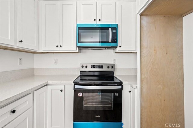 941 E 97th St, Los Angeles, CA 90002 - kitchen with appliances with stainless steel finishes, white cabinetry, and light countertops