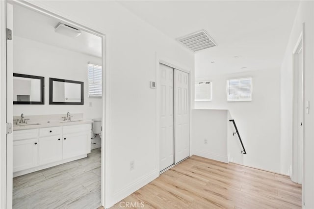 941 E 97th St, Los Angeles, CA 90002 - unfurnished bedroom with a sink, light wood finished floors, and baseboards
