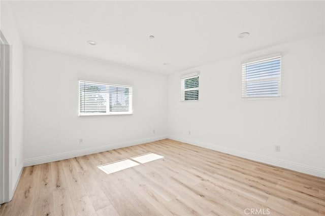 941 E 97th St, Los Angeles, CA 90002 - unfurnished room with plenty of natural light, light wood-style floors, and baseboards