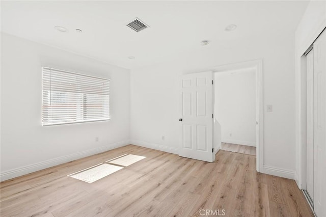 941 E 97th St, Los Angeles, CA 90002 - unfurnished bedroom featuring light wood-type flooring, baseboards, and a closet