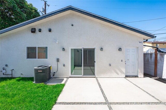 941 E 97th St, Los Angeles, CA 90002 - back of house with central AC, a patio, and stucco siding