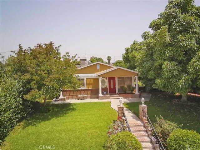 431 W M St, Colton, CA 92324 - view of front of home with a front yard, covered porch, and stucco siding